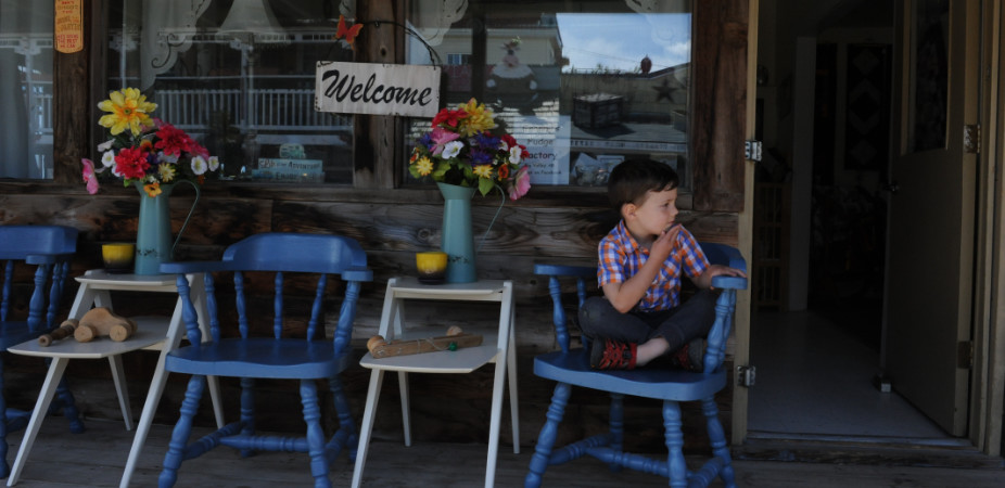 Kid sitting outside of a cafe in Stettler