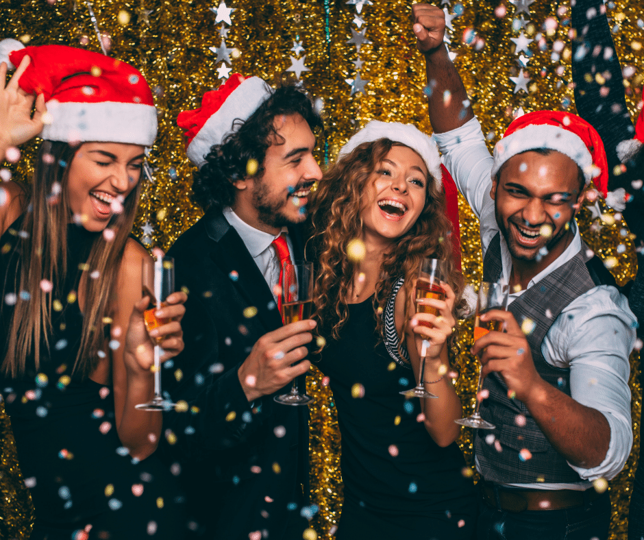 People dancing in Christmas santa hats