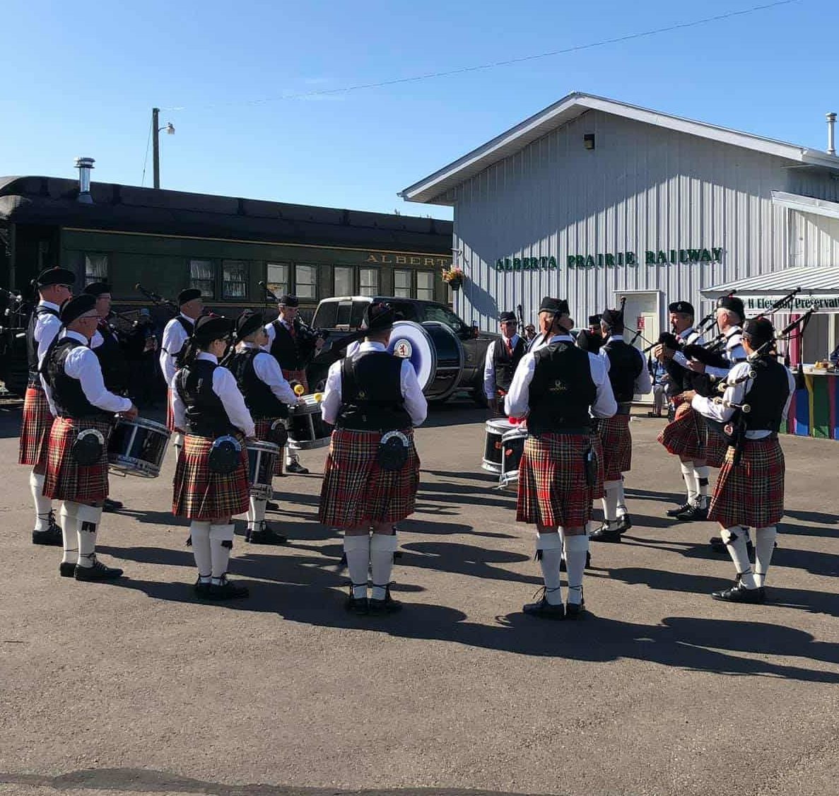 Red Deer Highland Band entertains prior to departure and again in concert at Big Valley.